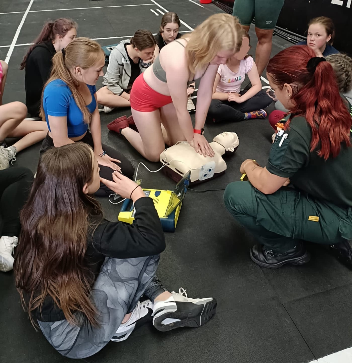 Young people learning first aid and CPR at a session